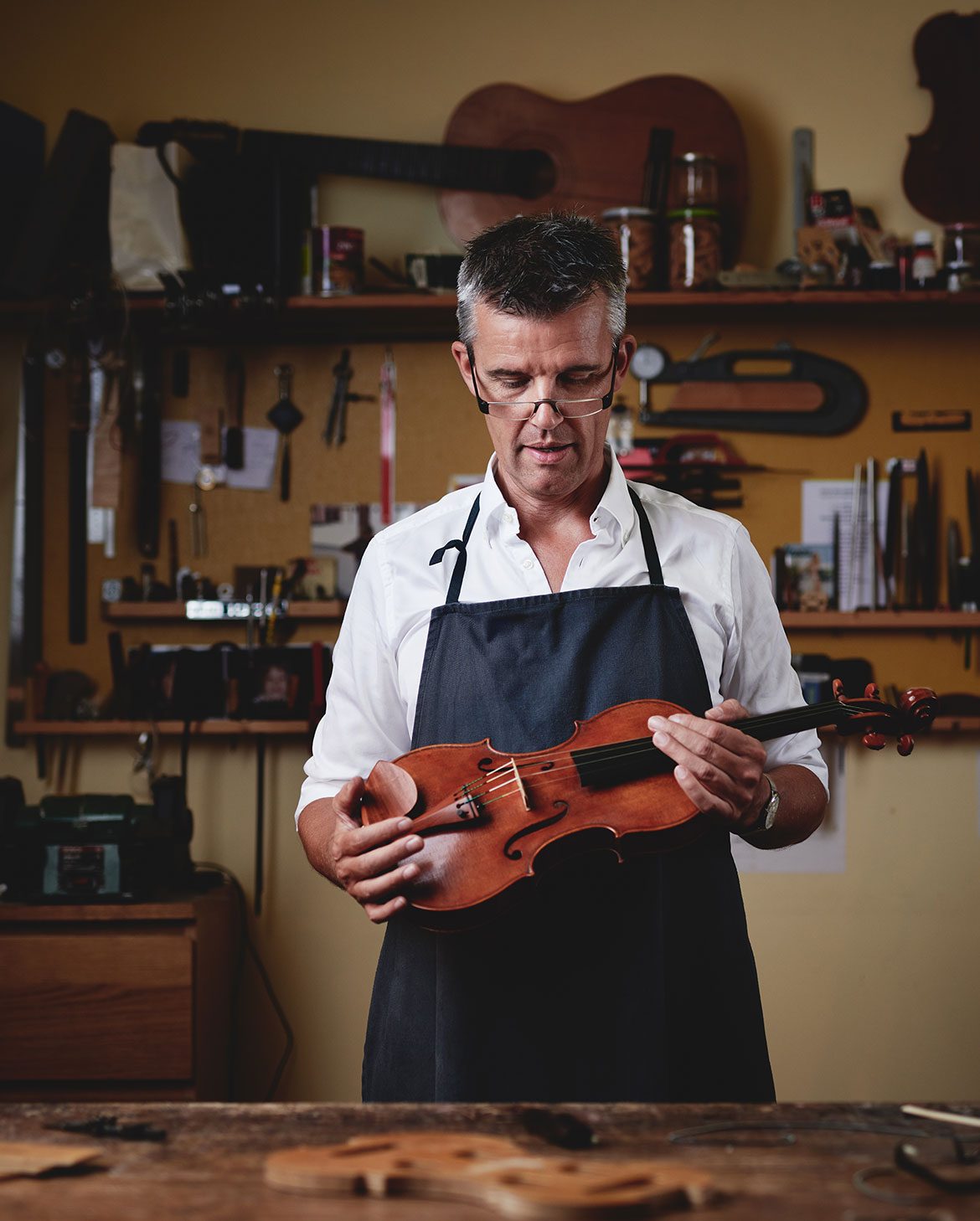 The Master Violin maker Edgar Russ holds one of his violins. Copyright Koeningshofer